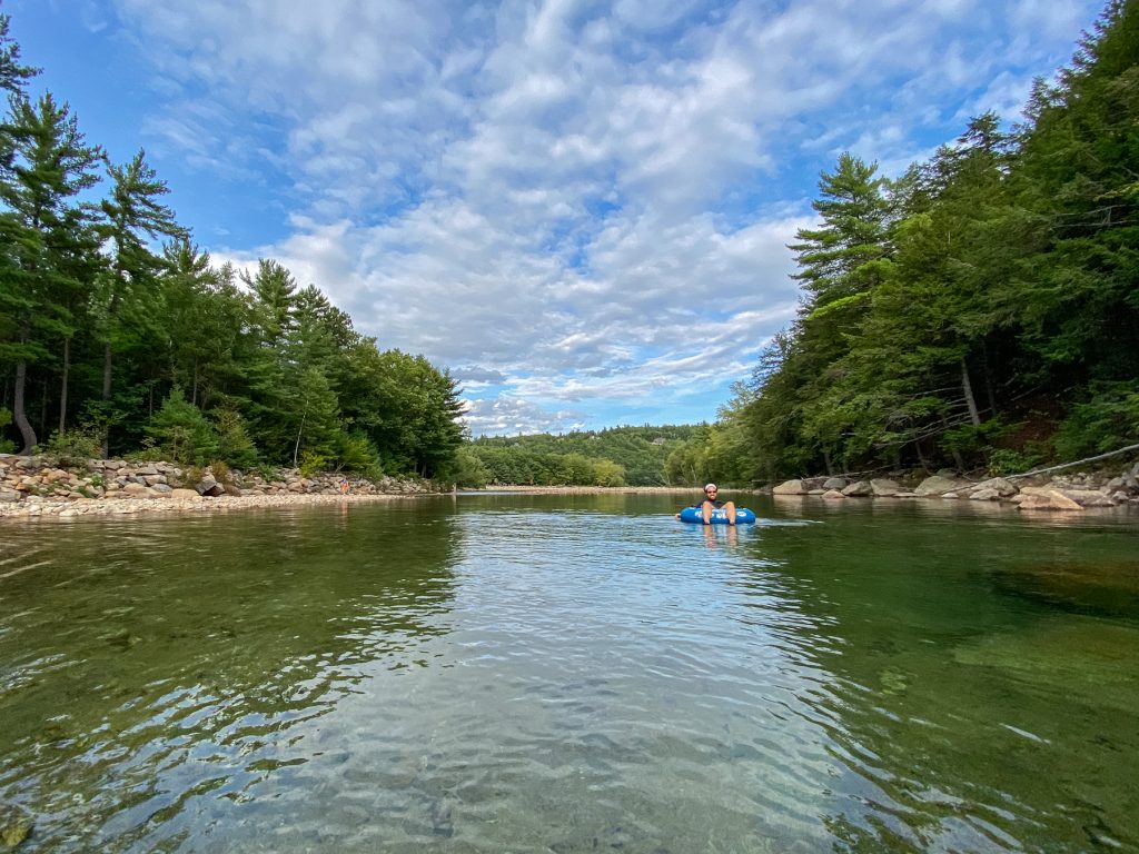 A man sits in a tube in the Glen river at Yogi Bear's Jellystone Park: Glen Ellis in Glen, New Hampshire.