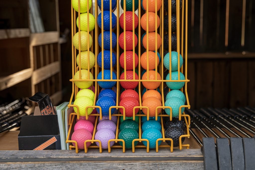 A rainbow of golf balls for mini golf.