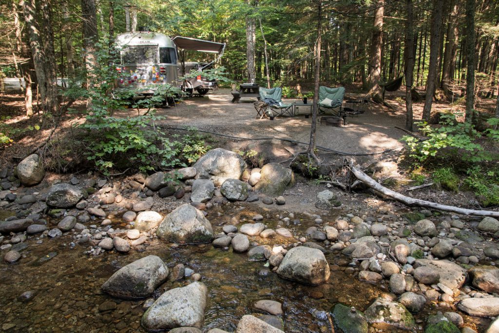 A stone-filled brook next to a campground site at Lost River Valley Campground in North Woodstock, New Hampshire.