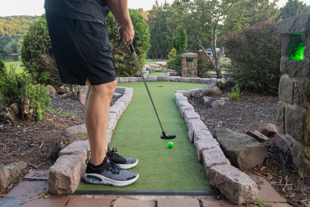 A man puts while playing mini golf at Lake In Wood RV Resort in Narvon, Pennsylvania.