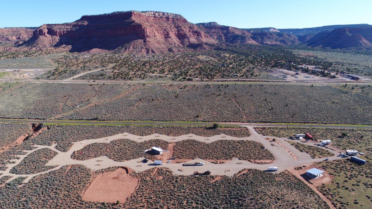 Aerial view of Dark Sky RV Campground overlooking red cliffs.