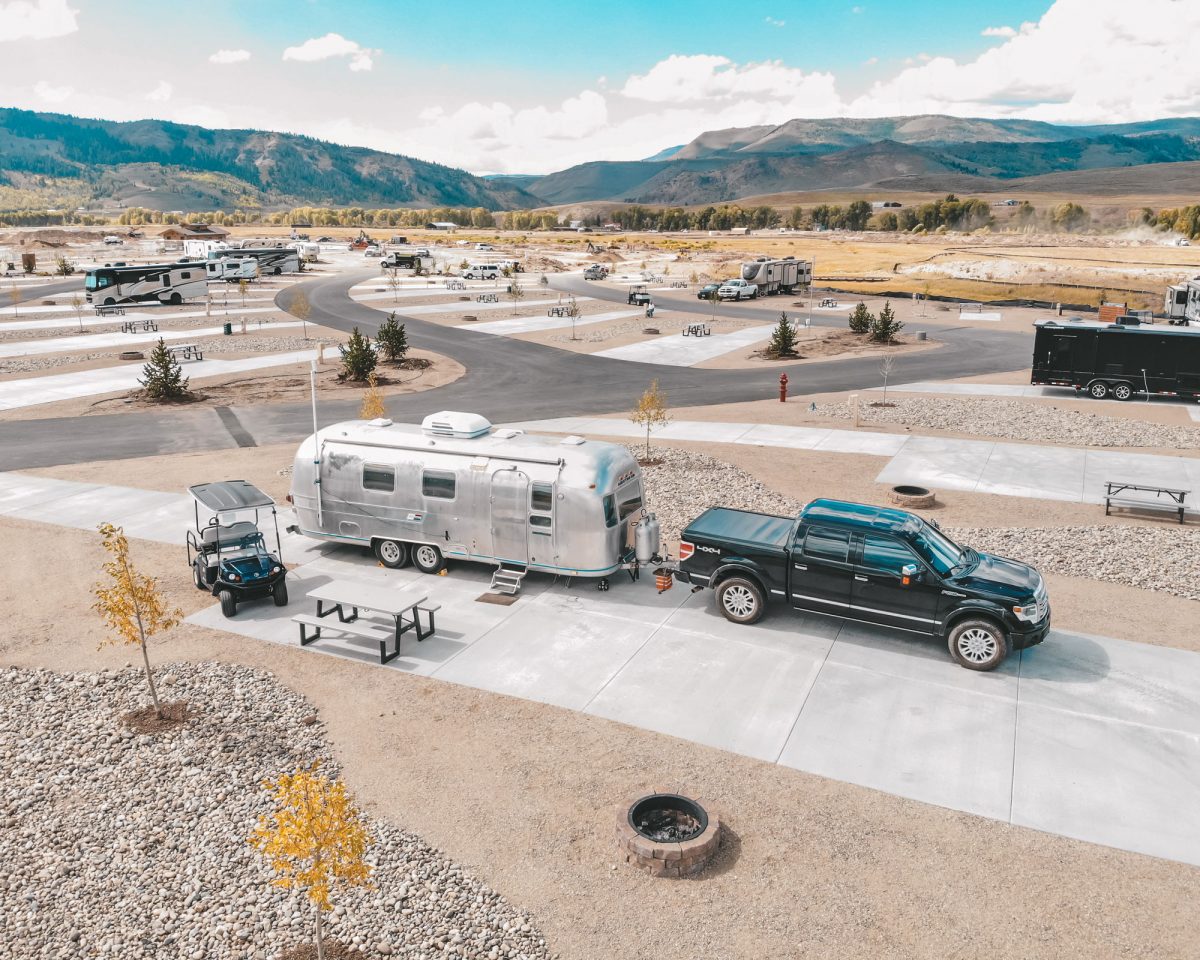 Pull-through RV sites with mountain in distance.