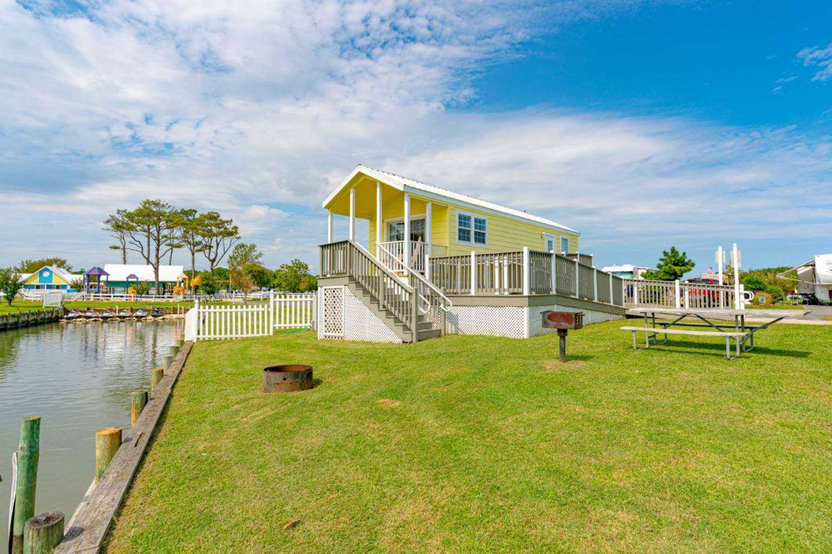 Yellow glamping cabin on the water at Castaway RV Resort.