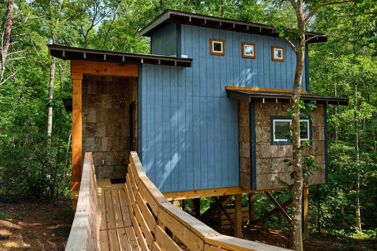 Blue treehouse in the woods at Emberglow in North Carolina.