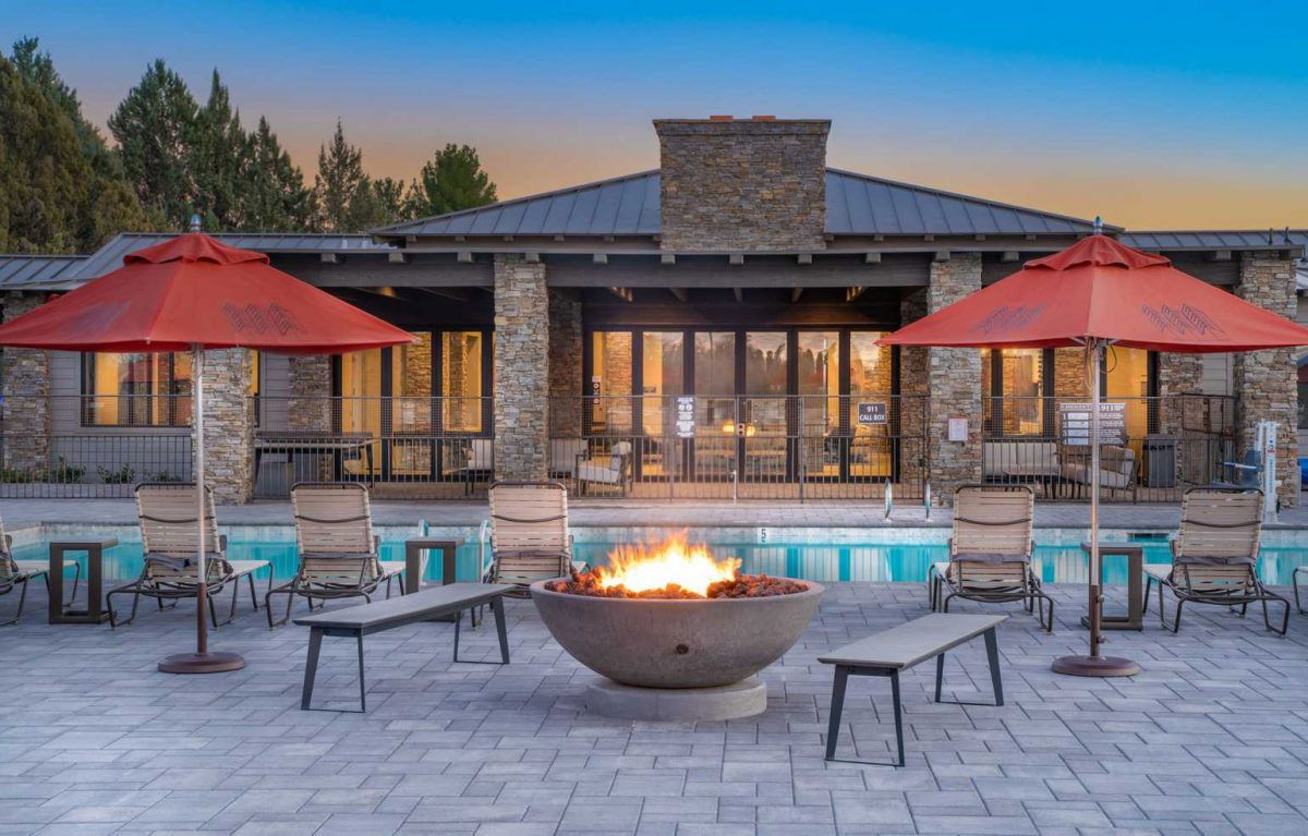 Outdoor pool area at sunset with fireplace at Verde Ranch RV.