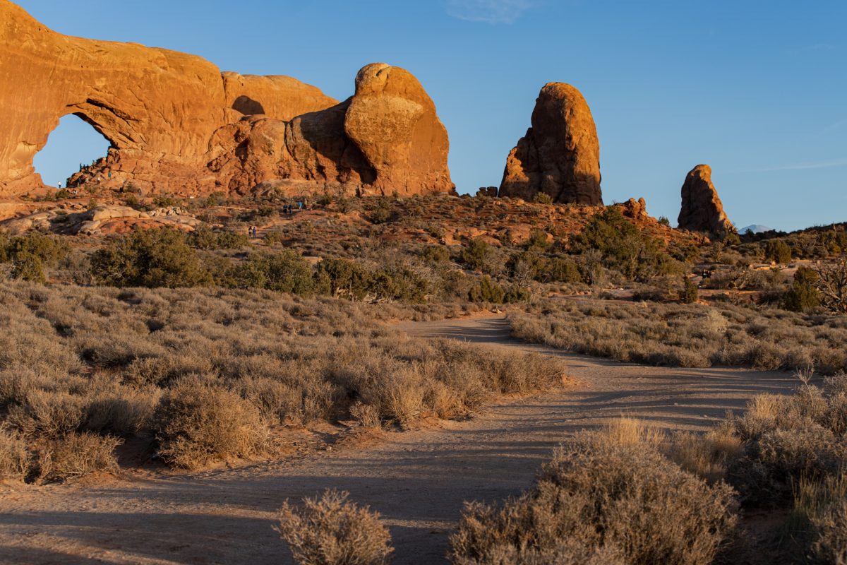 Windows Arch cast with a glowing light during sunset in Arches National Park in Moab, Utah.