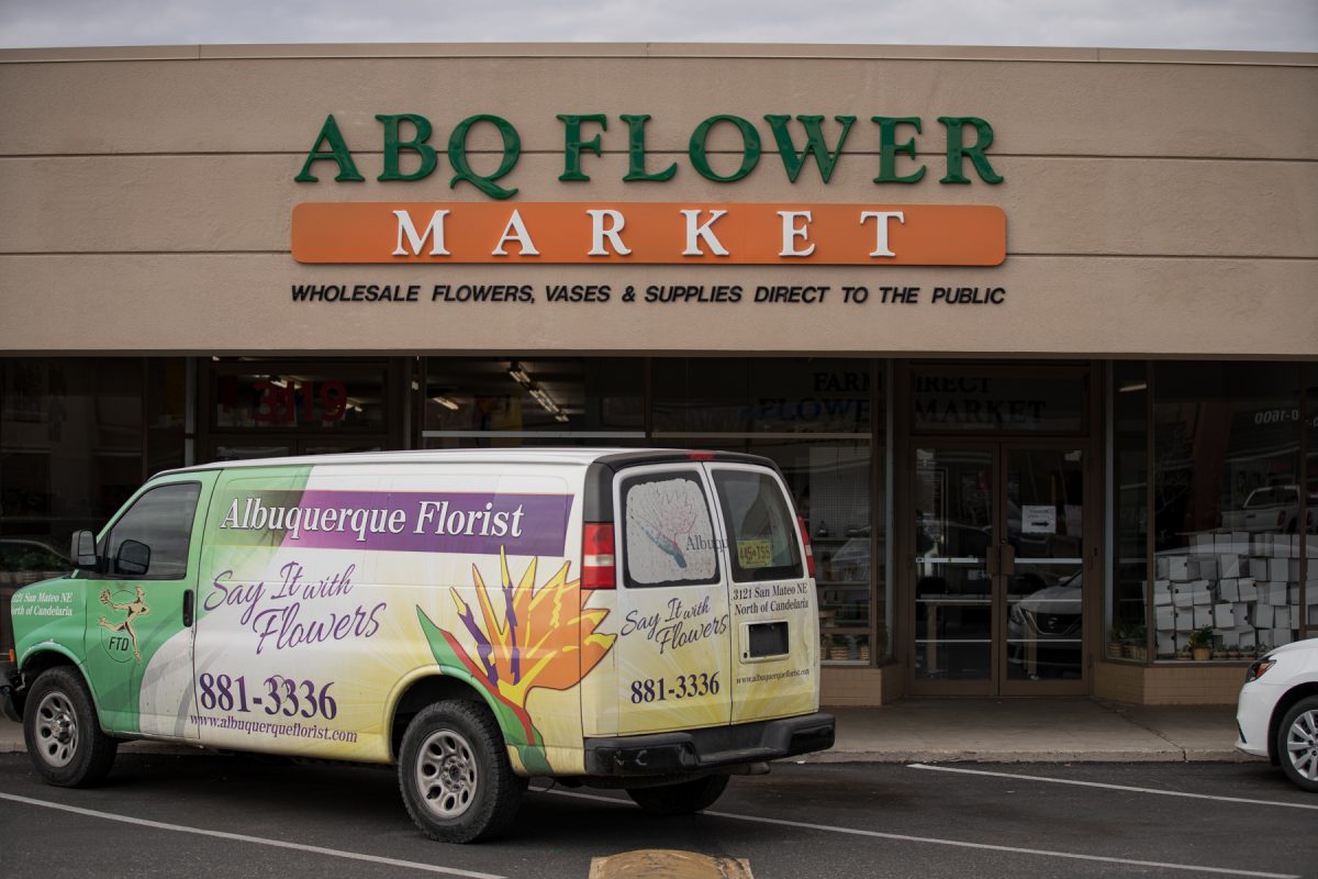 Storefront of the Albuquerque Flower Market in Albuquerque, New Mexico. The store's van sits in front of the shop.