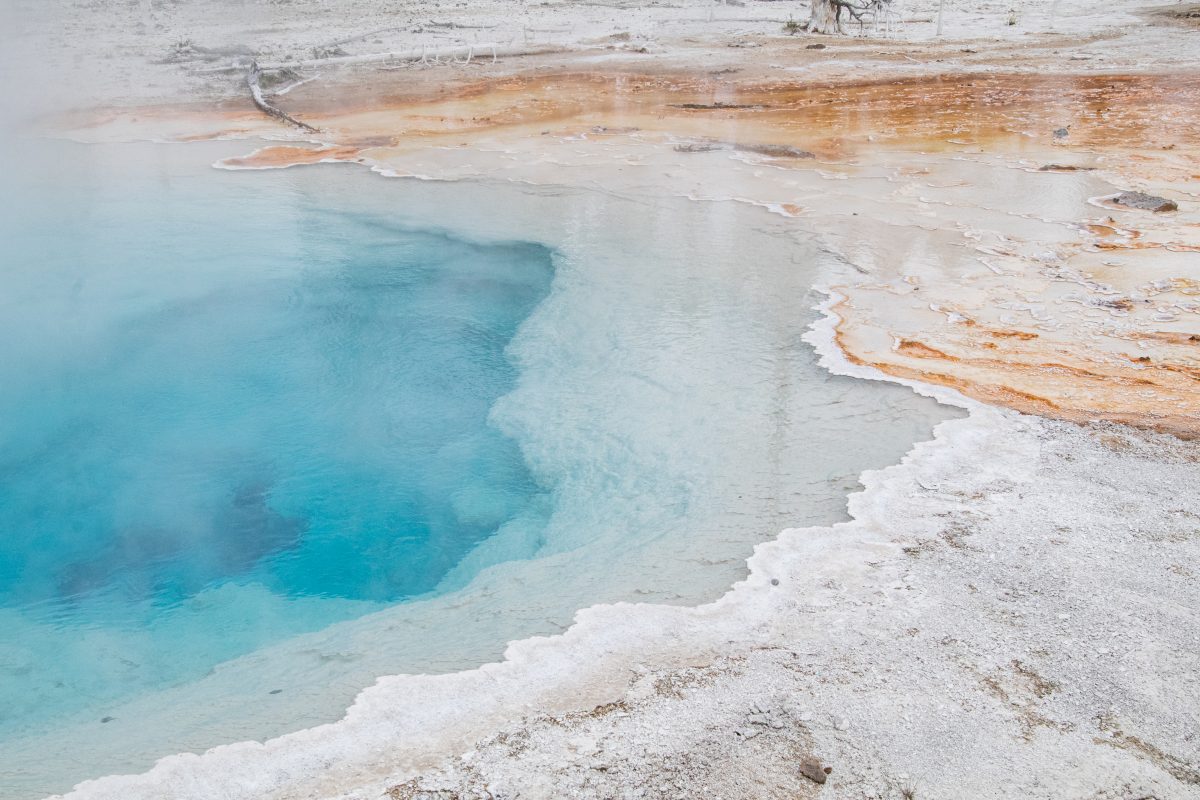 A closeup of a blue and orange thermal pool at Yellowstone National Park in Wyoming.