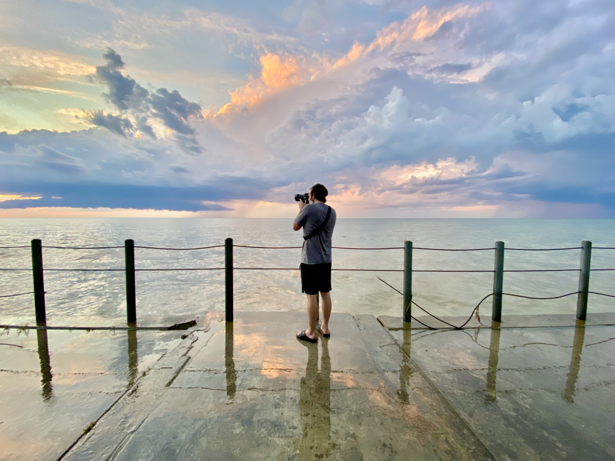 Tyler D. Way capturing a photo of the sunset. 