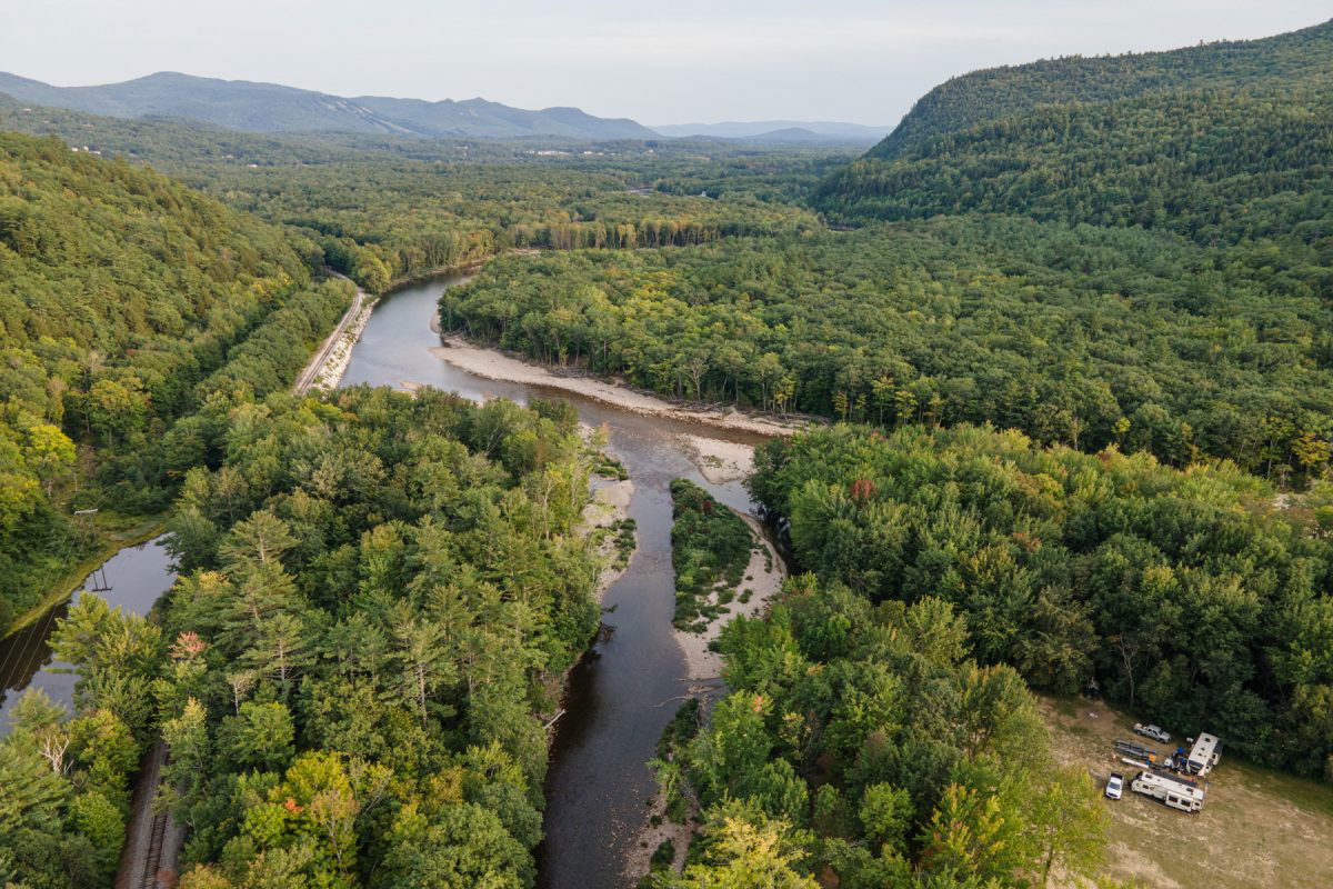 Ariel Photo of Glen Elis campground with RVs parked next to the river and the forest. 