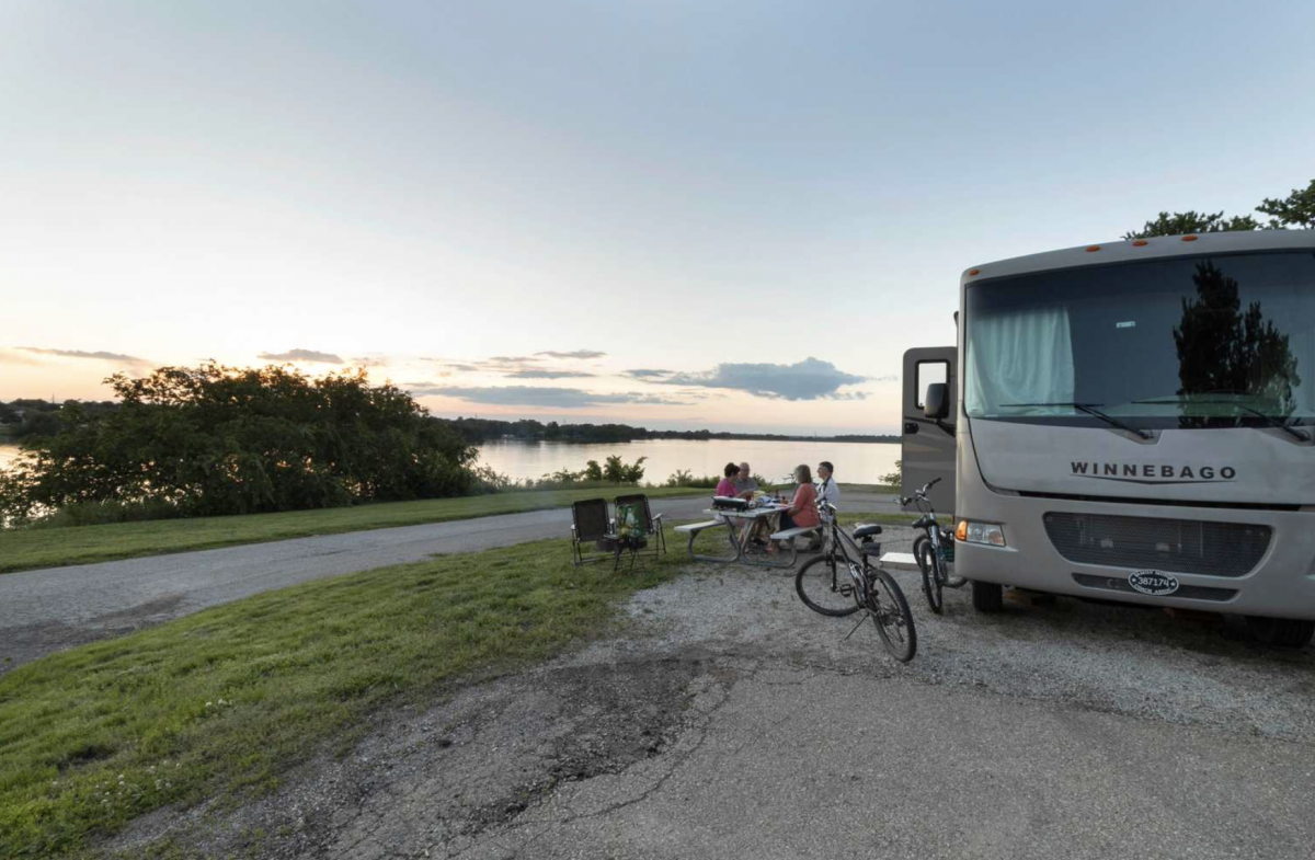 Winnebago parked next to lake at Lake Shawnee Campground.