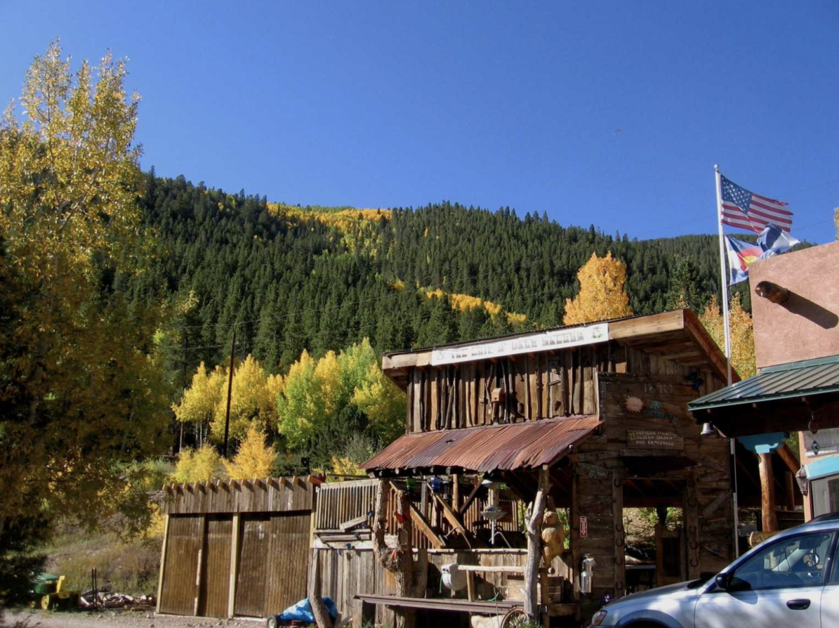 Building at Monarch Spur RV with mountain in the back and American flag. 