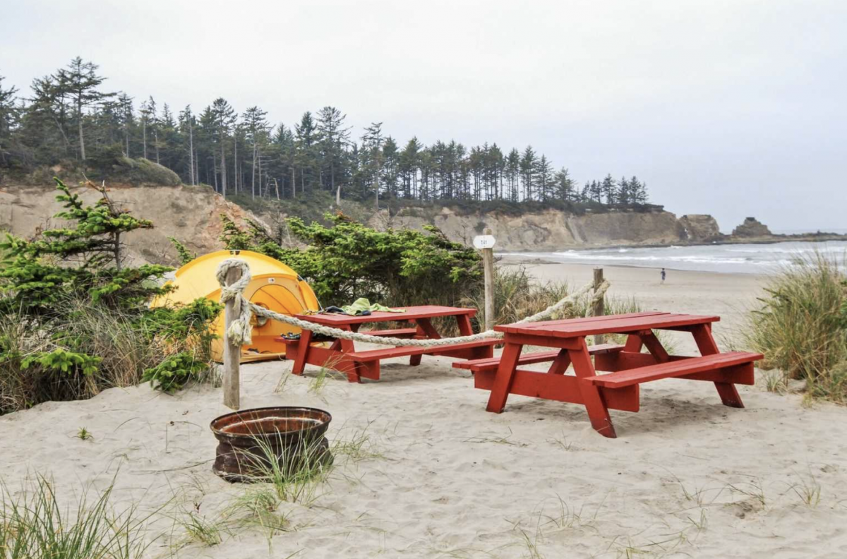 Tent and picnic table in front of the ocean at Oceanside RV Resort and Campground.