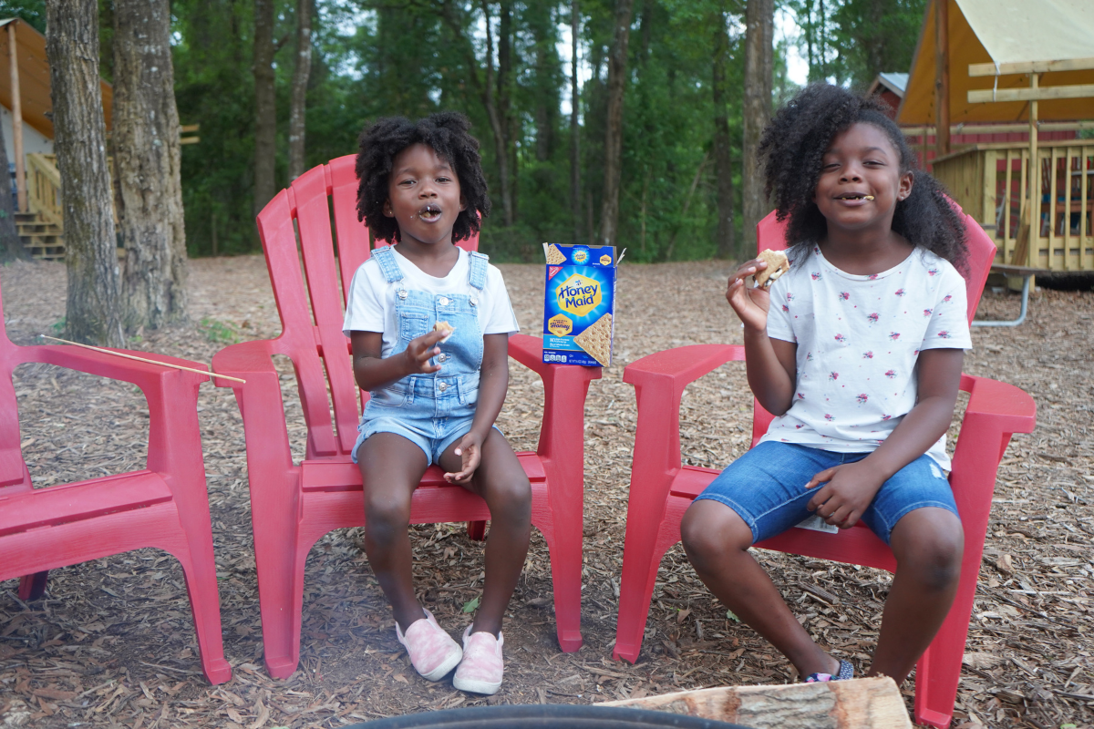 Hambrick Family making s'mores around the fire at the campground