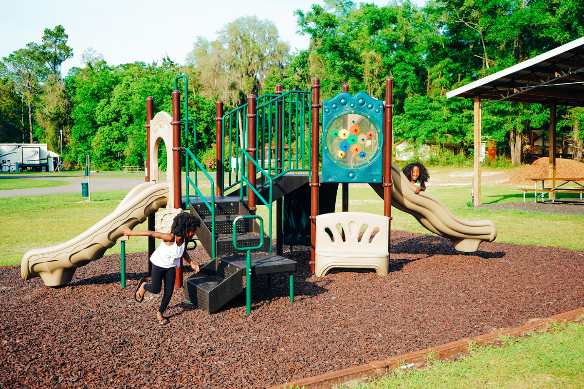 Hambrick Family on the playground going down the slide at Moonshine Acres RV Park