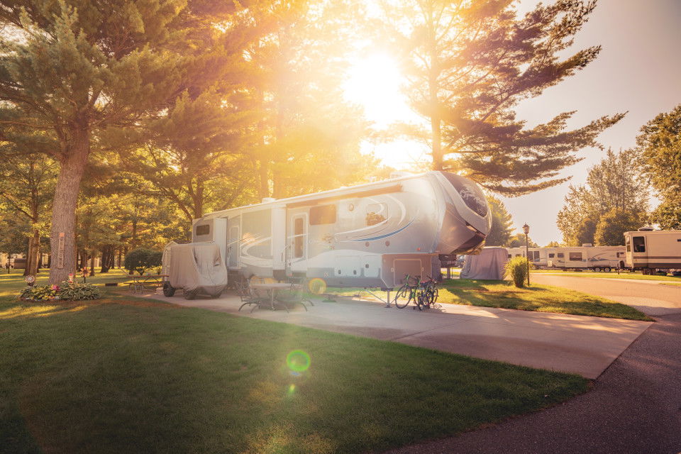 RV parked at Silver Creek RV Resort as the sun is setting.