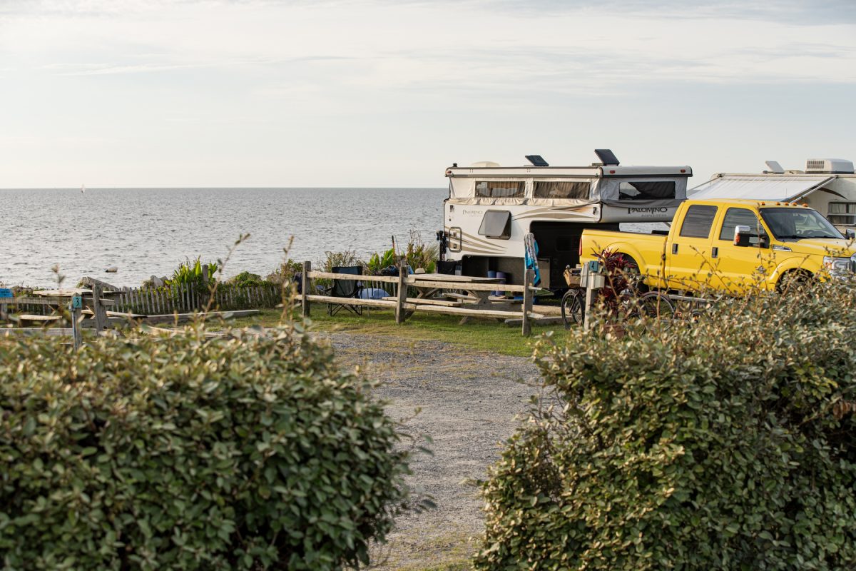 A pop up camper sits at a campsite along the water at Rodanthe Watersports and Campground in Rodanthe, NC.