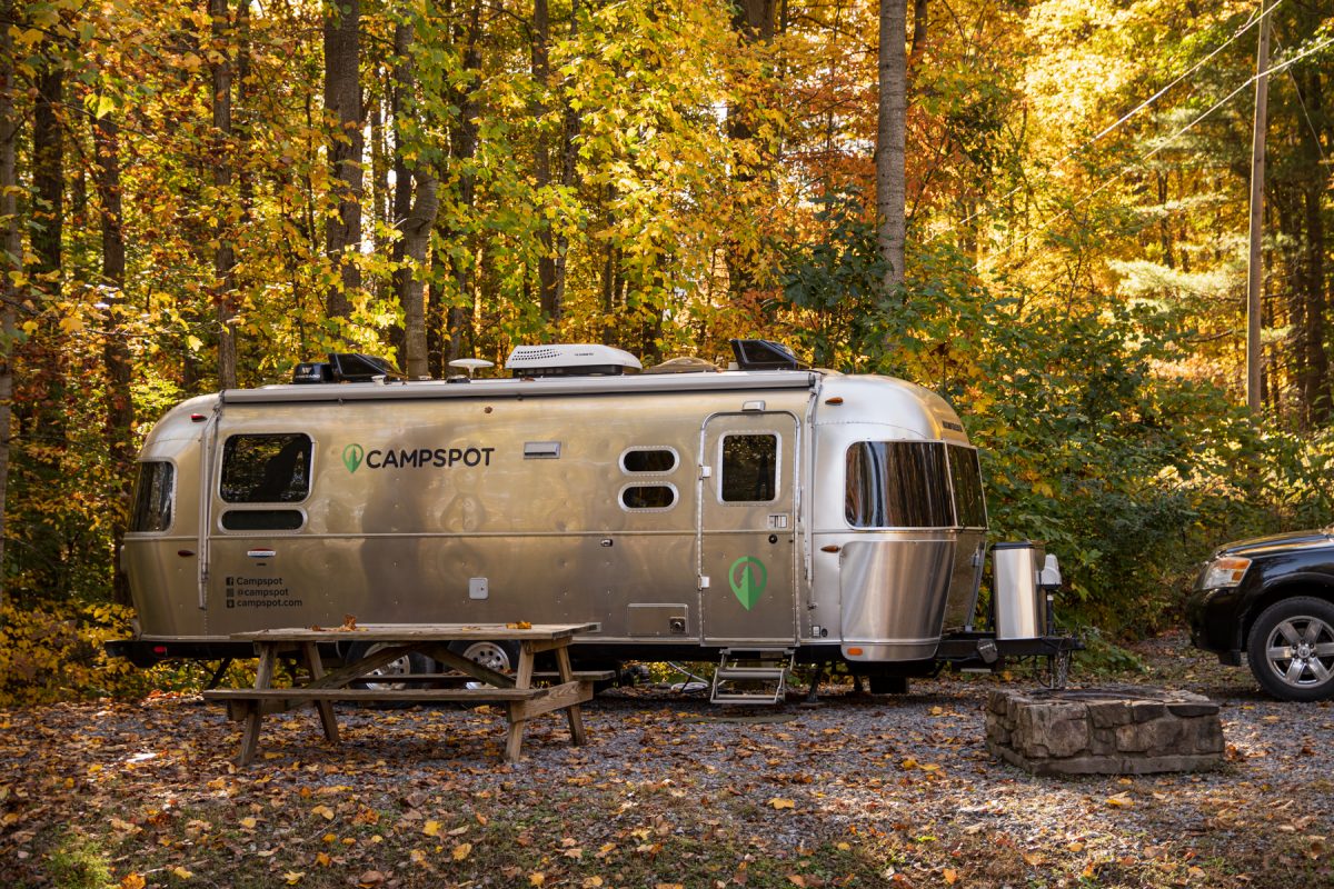 An Airstream sits within the forest camp sites at Paradise Stream Family Campground in Loysville, PA.