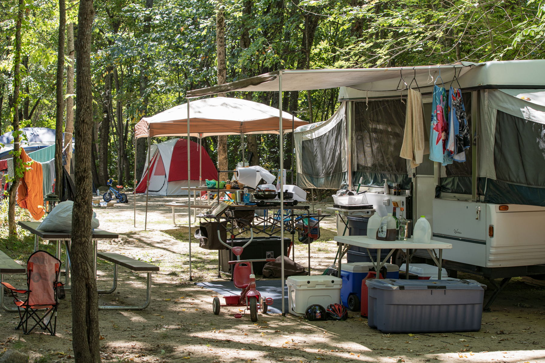 Camping equipment strewn about a campsite at Yogi Bear's Jellystone Park Camp-Resort: Glen Ellis in New Hampshire.