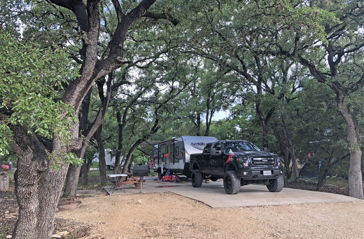 A travel trailer parked at a campsite at the Yogi Bear's Jellystone Park Camp-Resort: Hill Country in Canyon Lake, Texas.