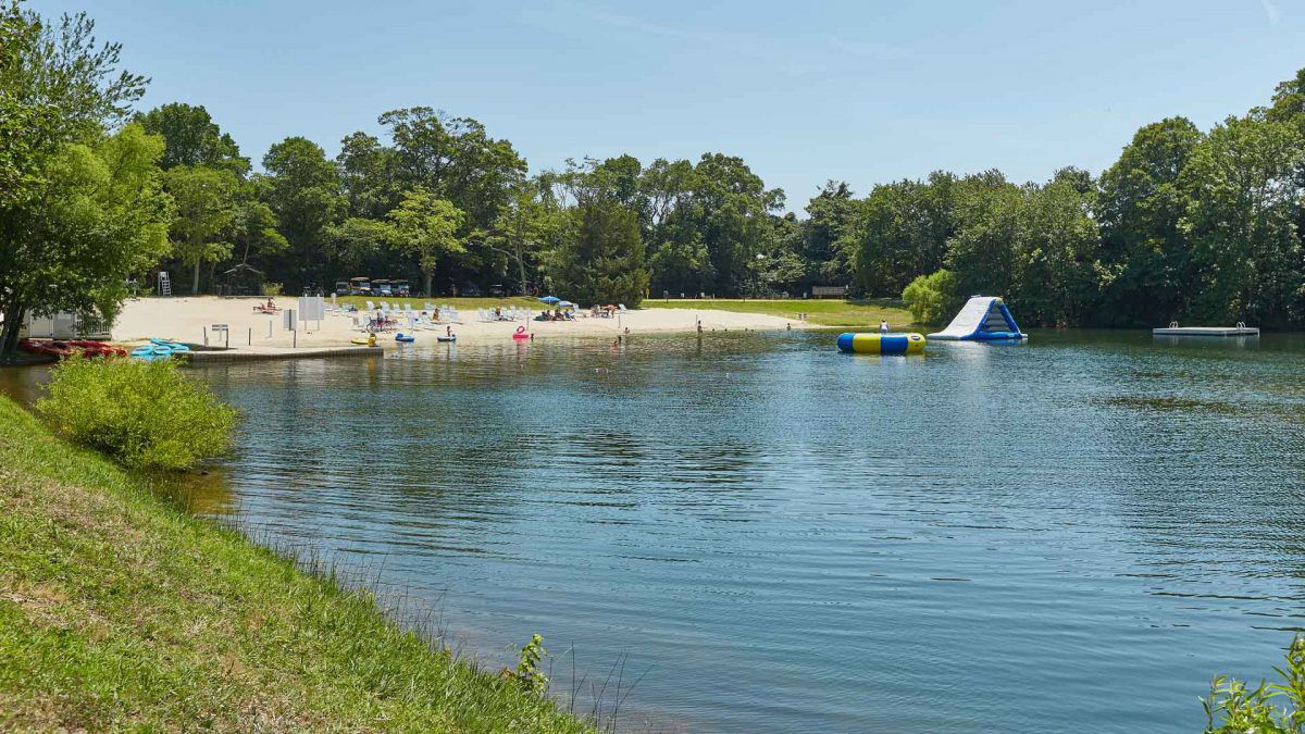 Lake with water slide and beach at Sun Outdoors 