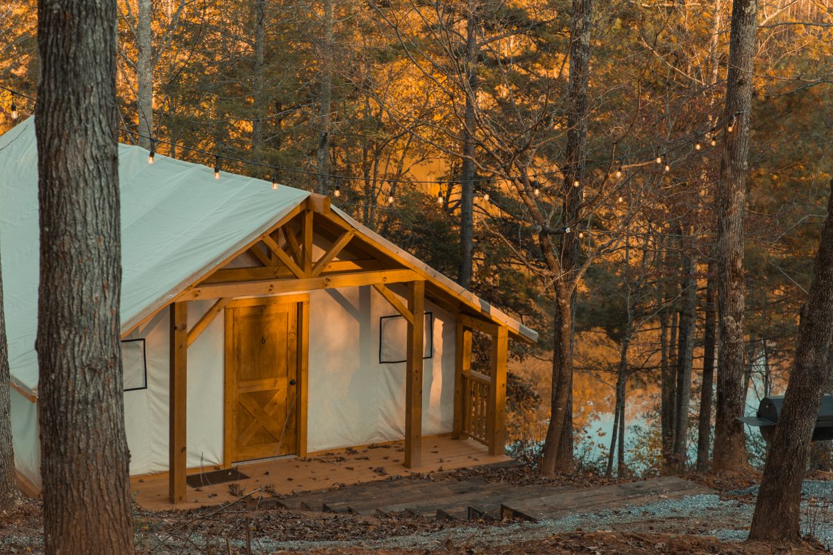 A glamping cabin surrounded by the golden fall leaves at Yogi Bear's Jellystone Park Camp-Resort: Golden Valley in Bostic, North Carolina.