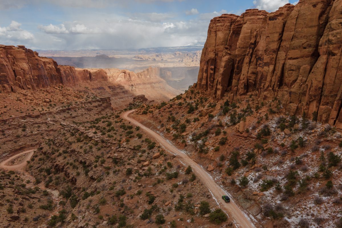 A jeep trailing down a red rock canyon in Moab, Utah.