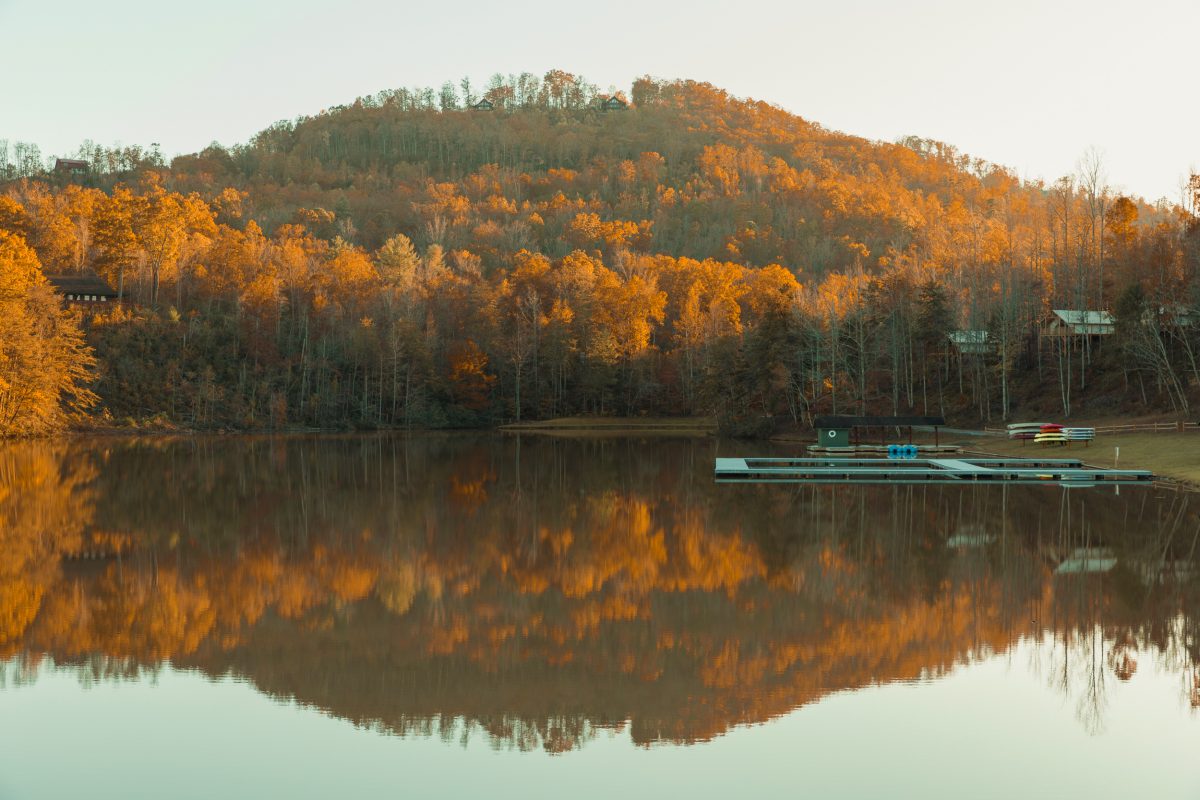 The golden trees reflecting off the water during the fall at Yogi Bear's Jellystone Park Camp-Resort: Golden Valley in Bostic, North Carolina.