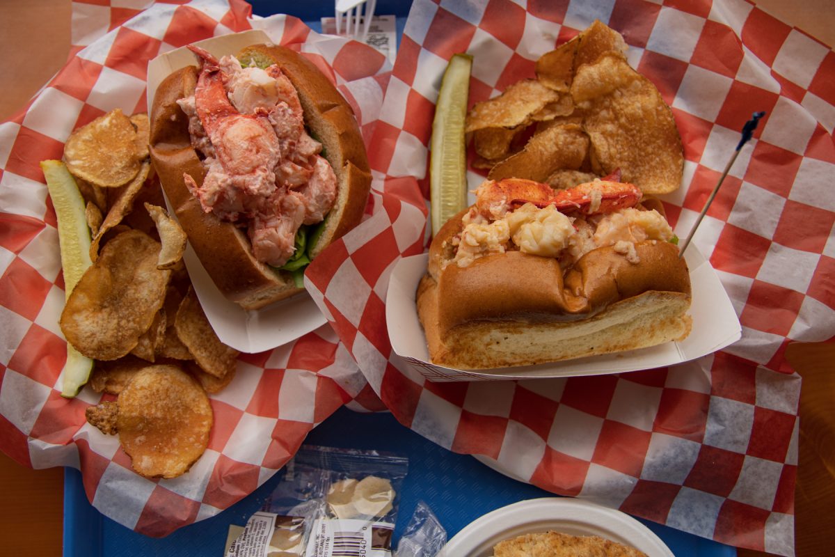 Lobster rolls sit on top of red and white checkered baskets. At Beal's Lobster Pier in Southwest Harbor.