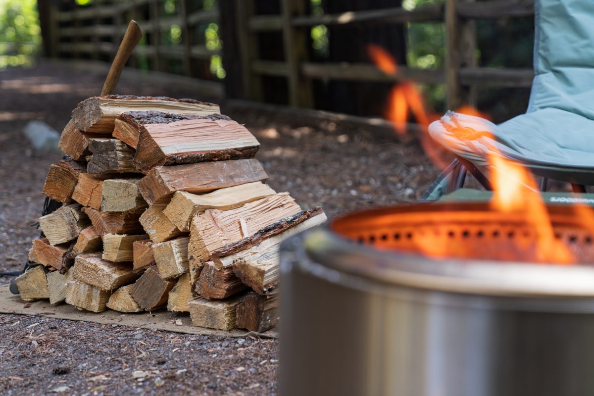 Firewood and a campfire in a Solo Stove at the Santa Cruz Redwoods RV Resort in Felton, California.