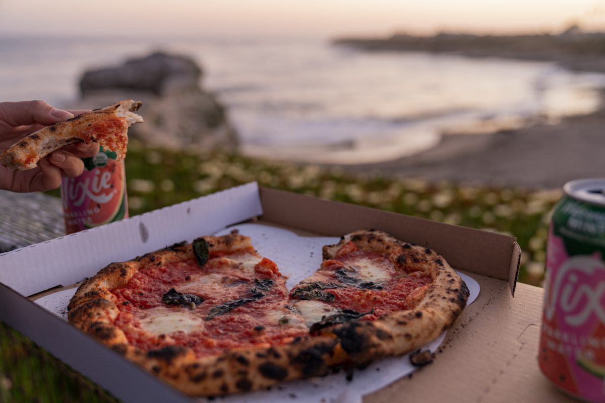 Pizza from Bantam in Santa Cruz, California, with sunset and Natural Bridges State Beach in the background.