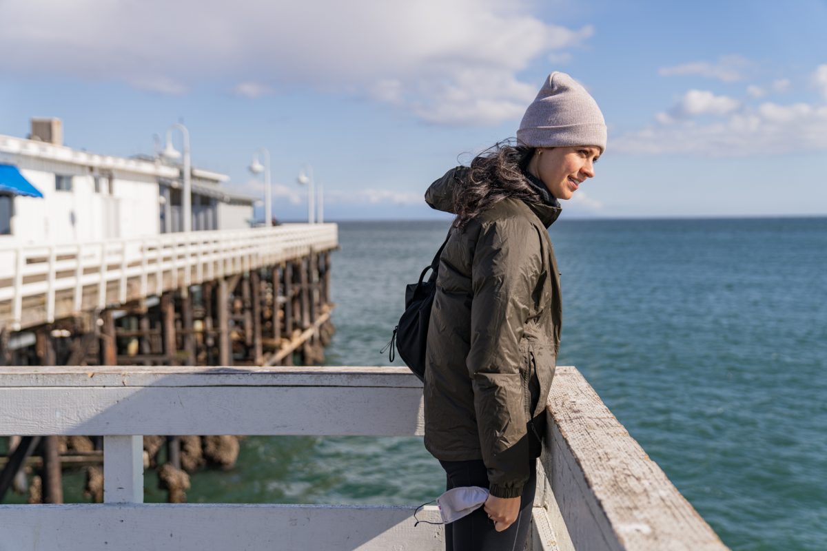 A person looking for sea lions on the Santa Cruz Wharf in Santa Cruz, California.