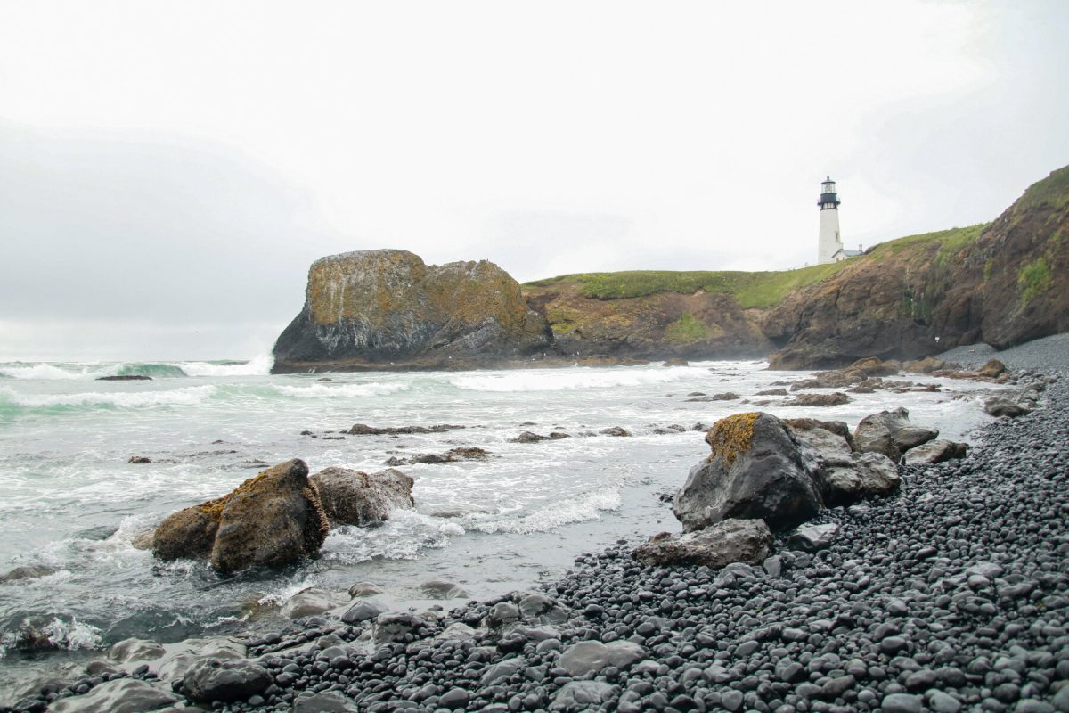 The oldest lighthouse in Oregon, the Yaquina Head Lighthouse overlooks the Oregon Coast, a popular Oregon camping destination.