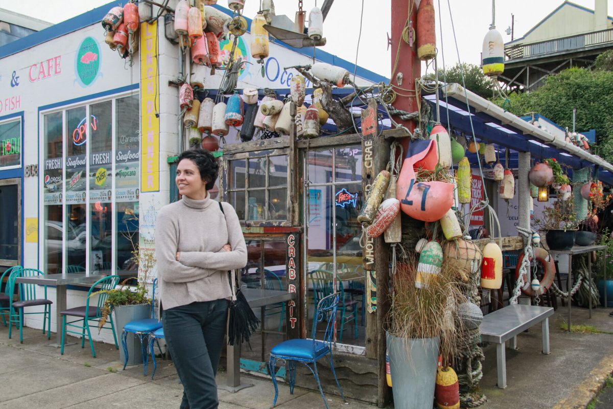 A woman stands outside of Ocean Bleu Seafood at Gino's in Newport, Oregon.