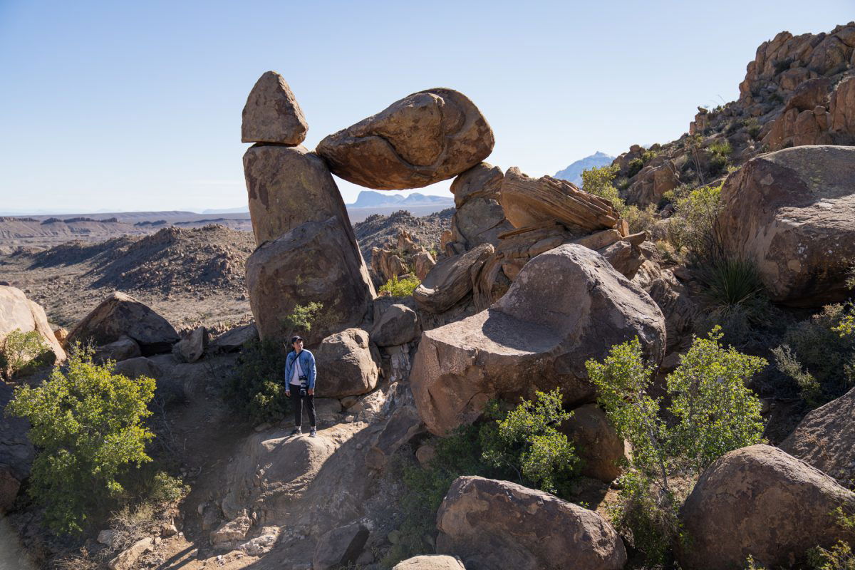 View of woman standing in front of rock formation at Big Bend National Park