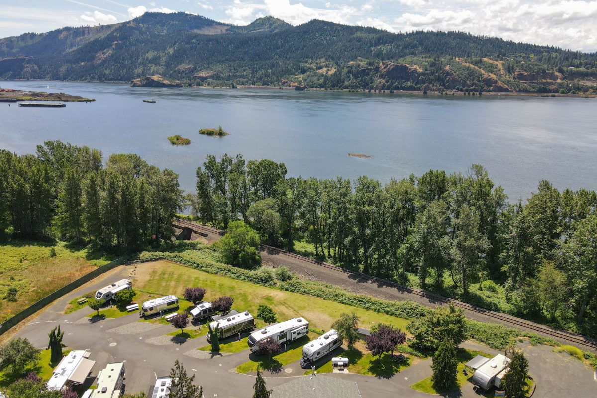 Aerial view of campground next to river with RVs parked