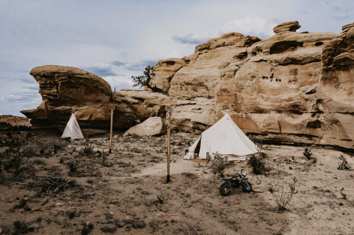 Glamping tents next to large rock formation at KitFox 