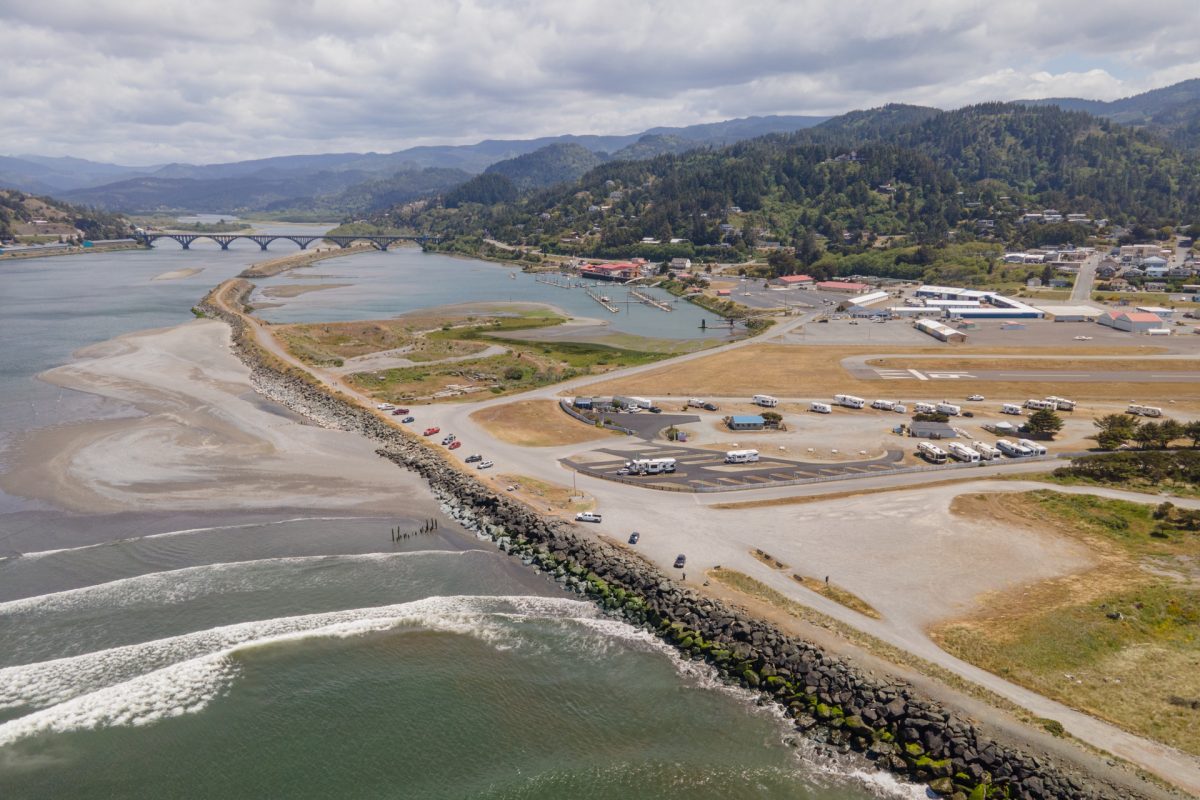 An aerial view of Oceanside RV Park in Gold Beach, Oregon, located on the Rogue River and the Pacific Ocean.