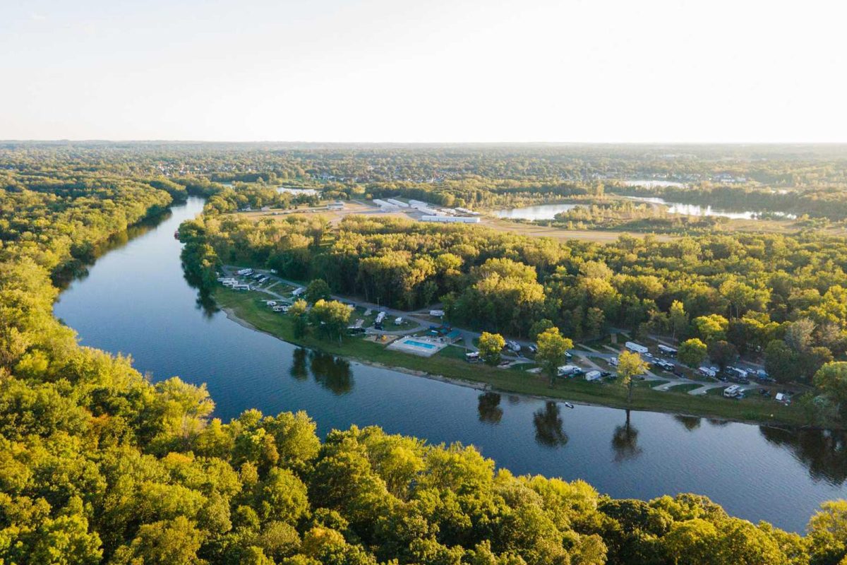 An aerial shot of campsites along a campground on a river. 