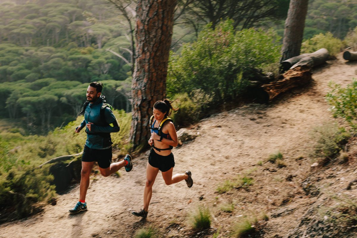 Two runners on a forest path. 