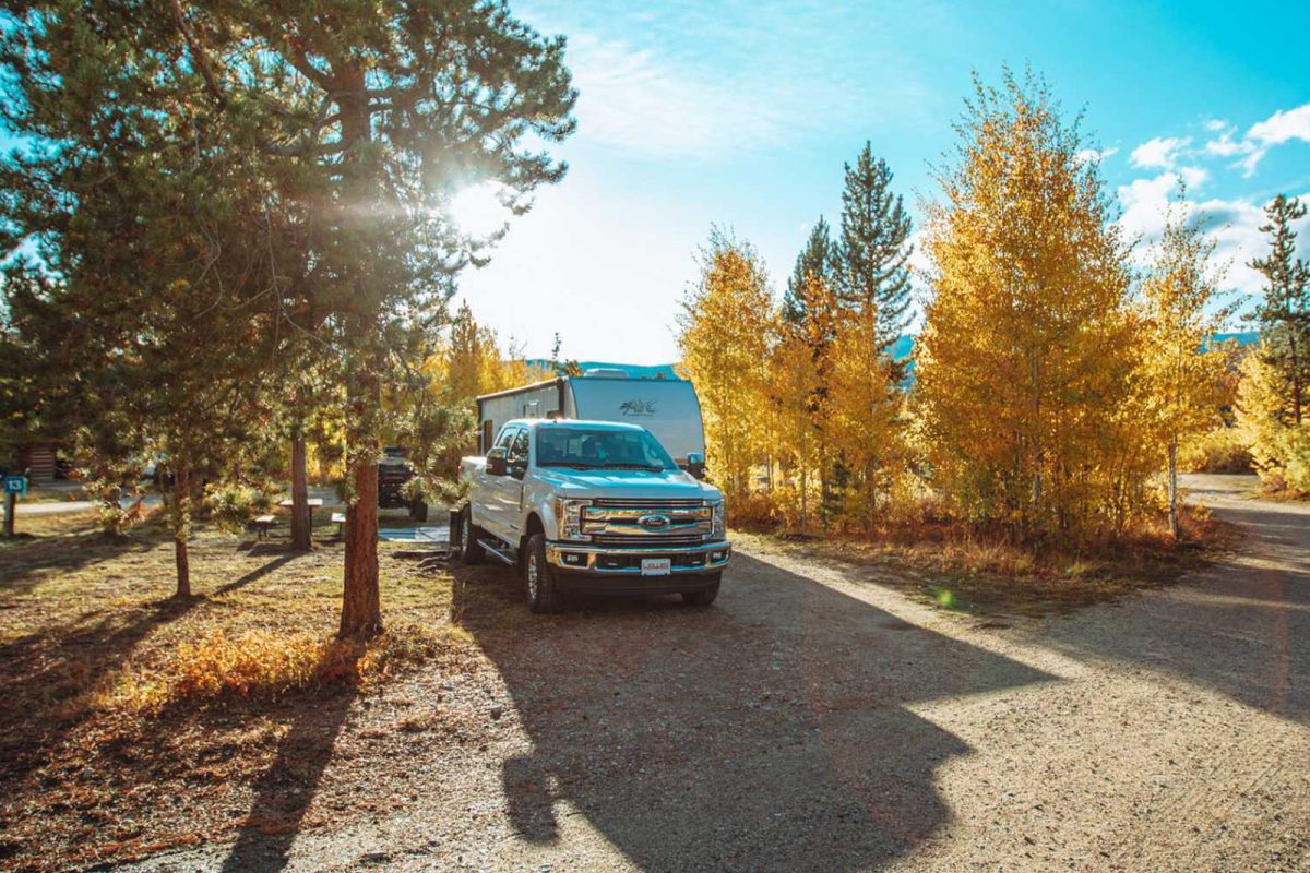 A truck and RV parked in an RV campsite at Winding River Resort, one of the most popular campgrounds for first time RV campers. 