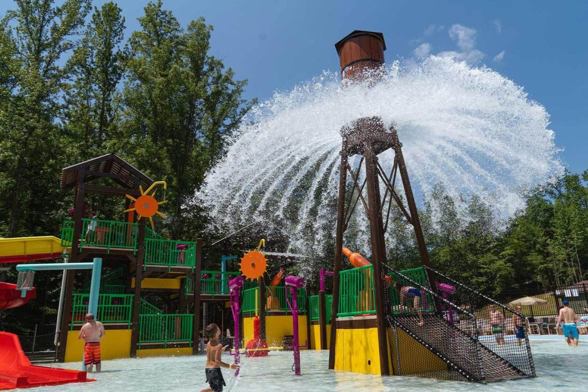 A bucket of water dumps on the campers below at the water park at Yogi Bear's Jellystone Park™ Camp-Resort: Golden Valley. 