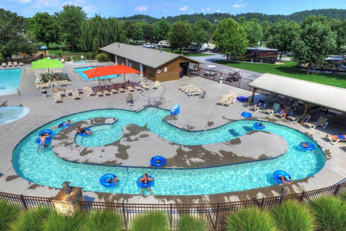 An aerial shot of the lazy river feature with several campers floating on blue inner tubes at Sun Outdoors Pigeon Forge. 