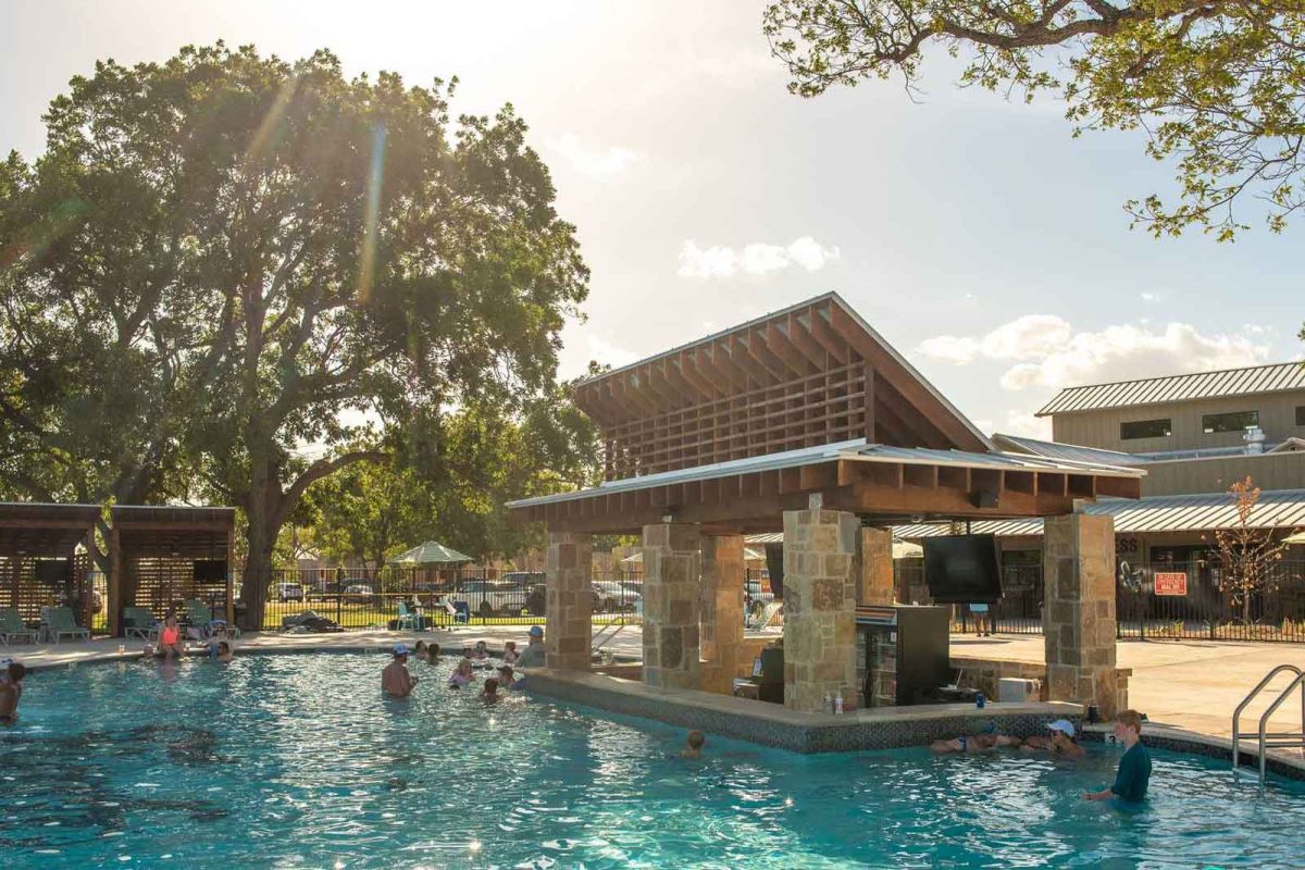 people playing in swimming pool at campsite