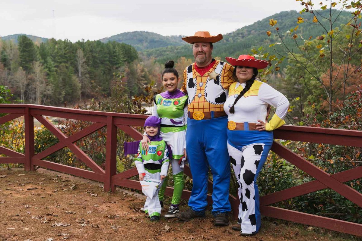 family in Toy Story-themed Halloween costumes on campground