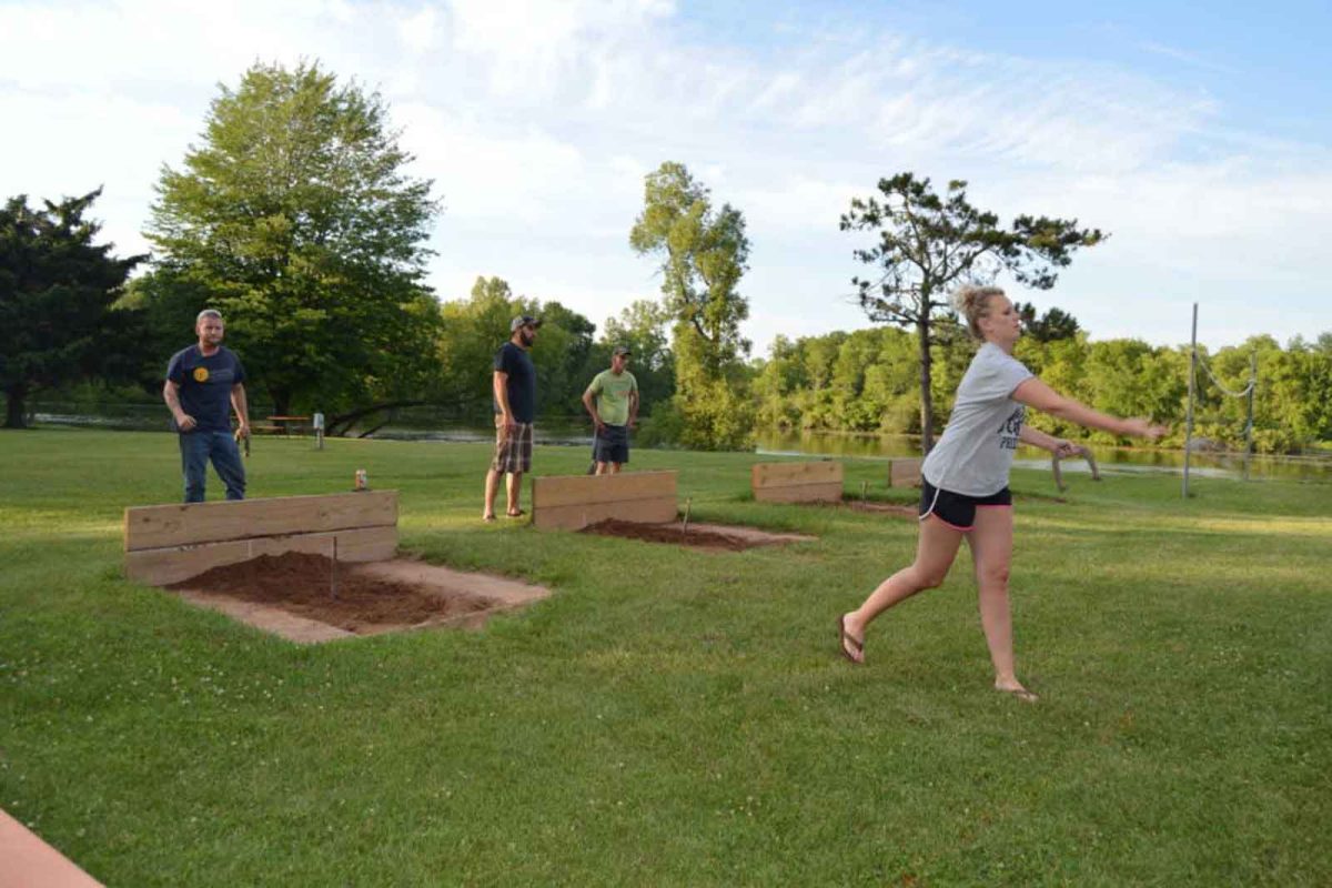 people playing horseshoe on campground