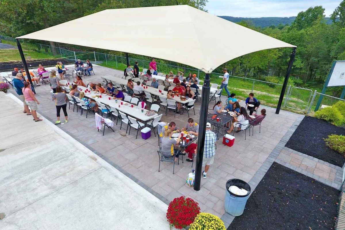 people gathered at eating area on campground