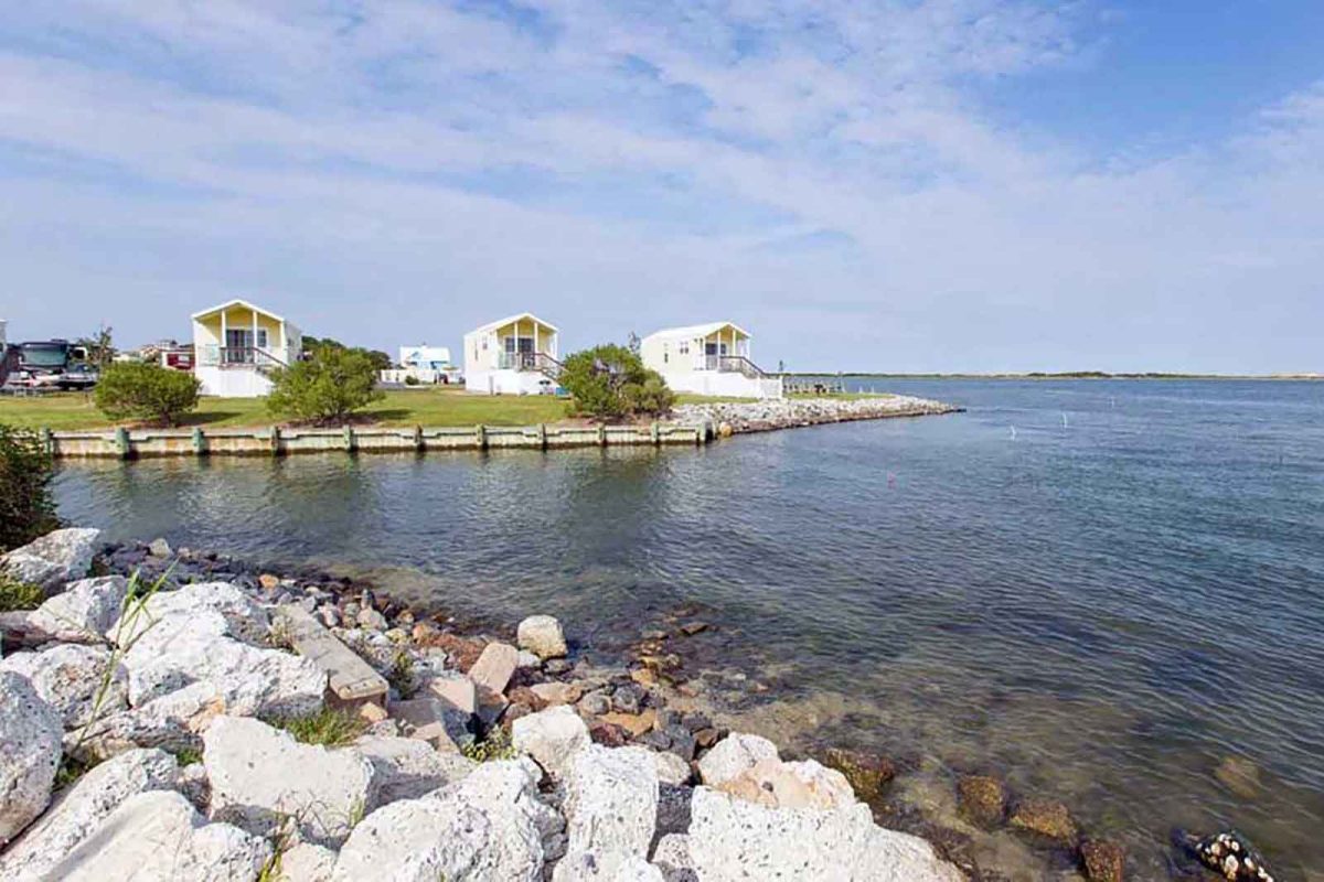 Three cabins on the water at Sun Outdoors Ocean City, a popular destination for Assateague Island camping. 