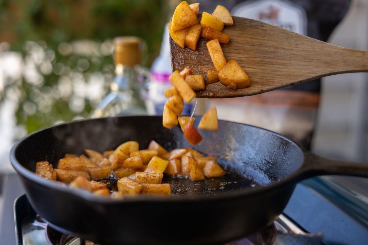 Apples cooking in a skillet on a camp stove 