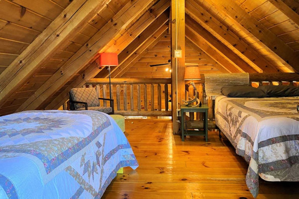 A bedroom loft inside a cabin 